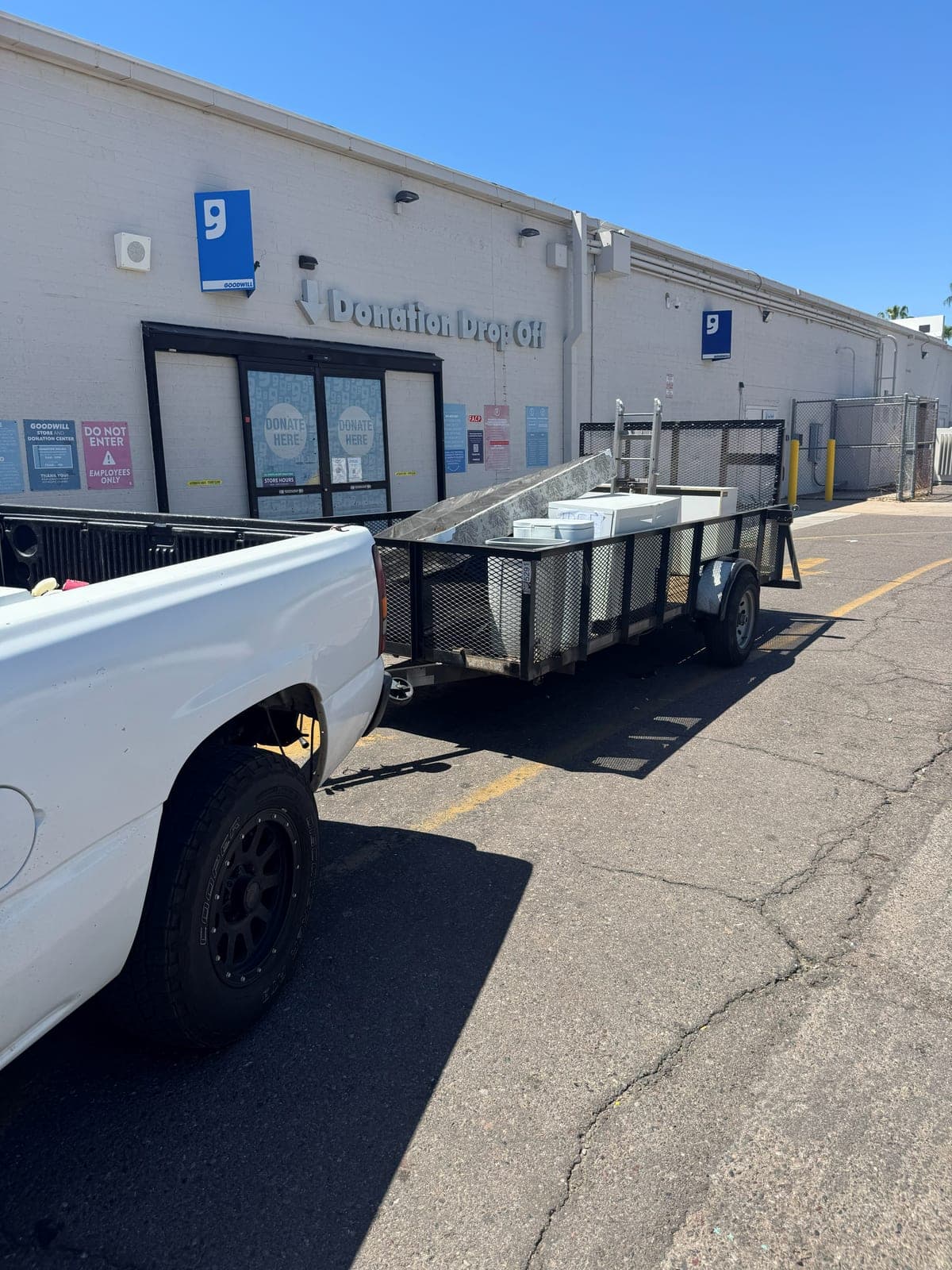 Sonoran Standard truck and trailer parked at the Goodwill donation drop off with a load from a junk removal job