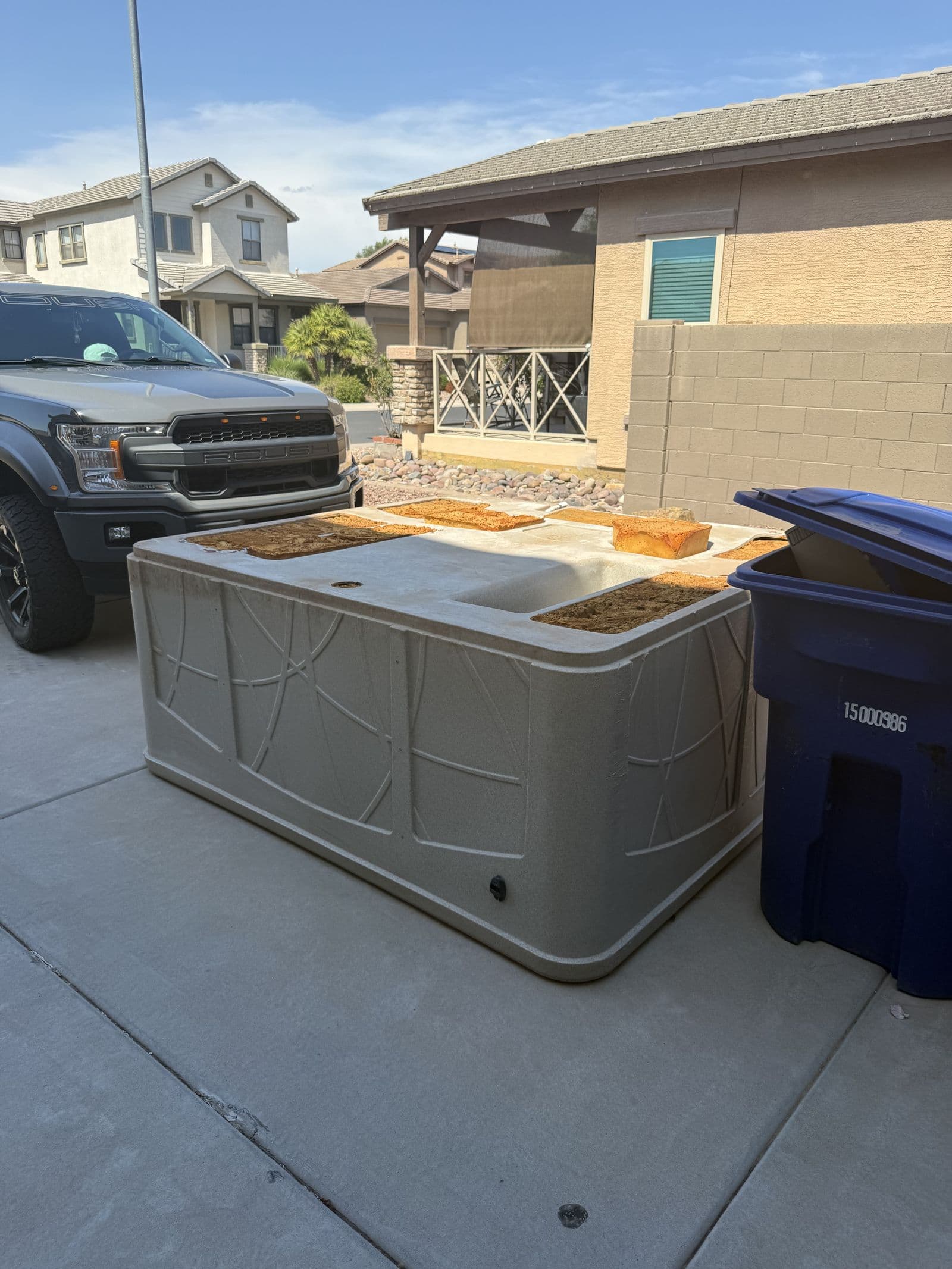 Old hot tub pulled out to the driveway for removal in the East Valley